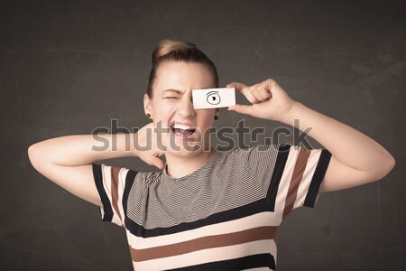 Young silly girl looking with hand drawn eye balls on paper Stock photo © ra2studio