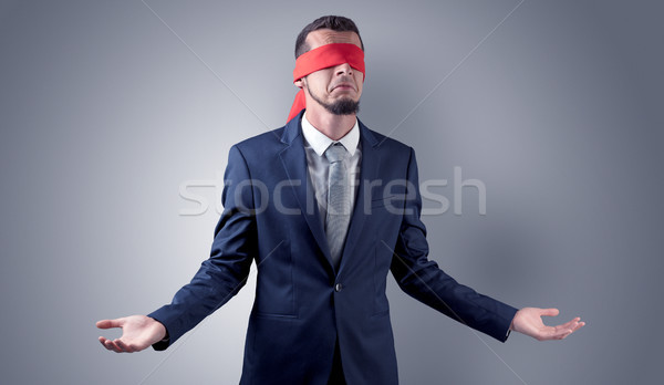 Covered eye businessman in front of a wall Stock photo © ra2studio