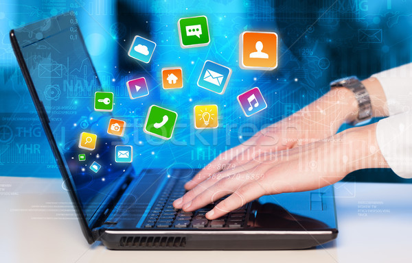 Hand using laptop with bouncing application graphs and report co Stock photo © ra2studio