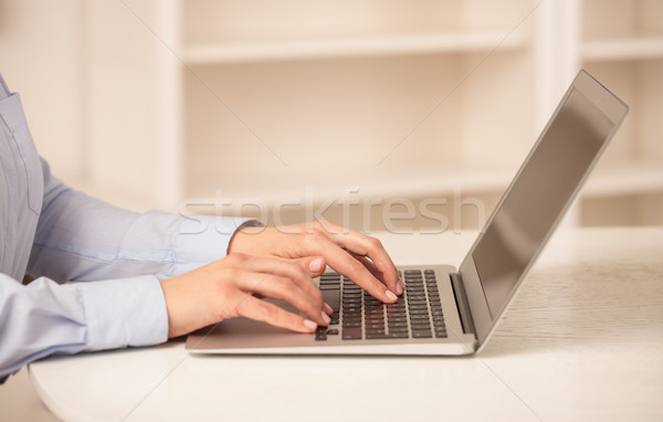 Business woman working on her laptop in a cozy environment Stock photo © ra2studio