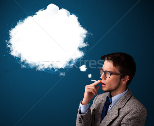 Young man smoking unhealthy cigarette with dense smoke Stock photo © ra2studio