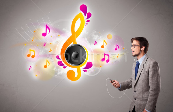 Jeune homme chanter écouter de la musique notes de musique sur bouche [[stock_photo]] © ra2studio