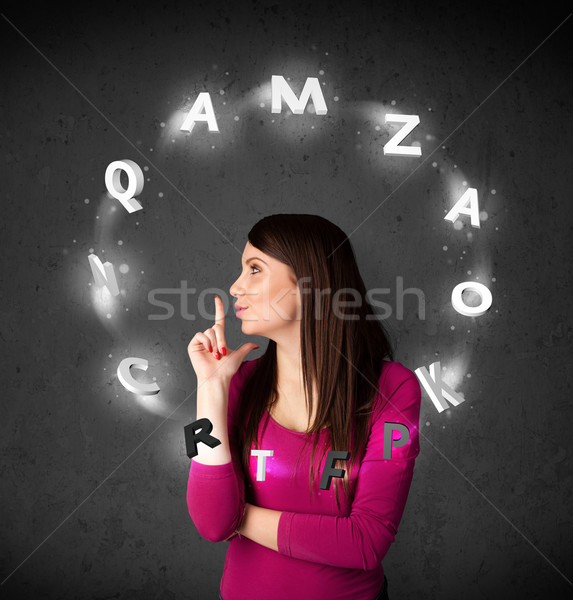 Stock photo: Young woman thinking with letter circulation around her head