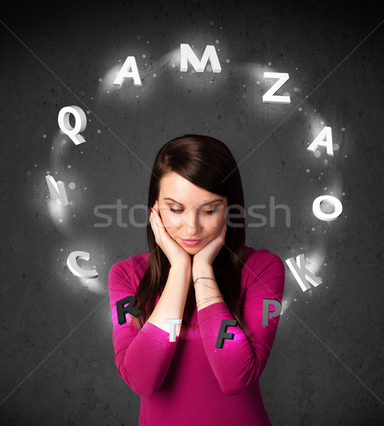 Young woman thinking with letter circulation around her head Stock photo © ra2studio