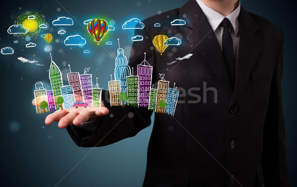 Young businessman presenting colorful hand drawn metropolitan ci Stock photo © ra2studio