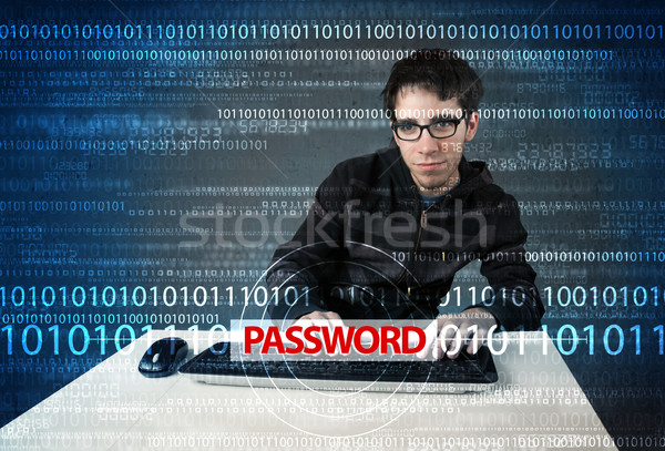 Stock photo: Young geek hacker stealing password 