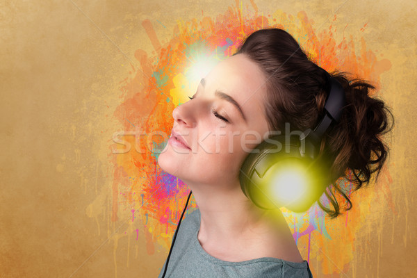 Young woman with headphones listening to music Stock photo © ra2studio