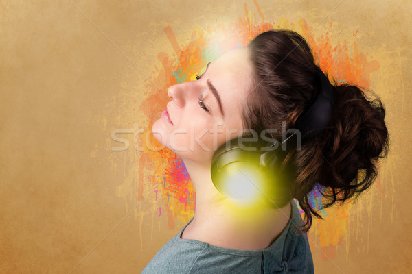 Young woman with headphones listening to music Stock photo © ra2studio