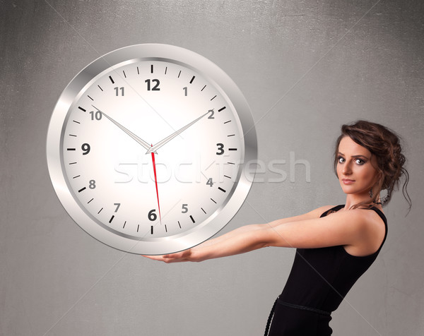 Attractive lady holding a huge clock Stock photo © ra2studio