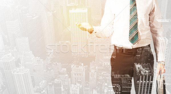 Business person with warm color overlay of city background Stock photo © ra2studio