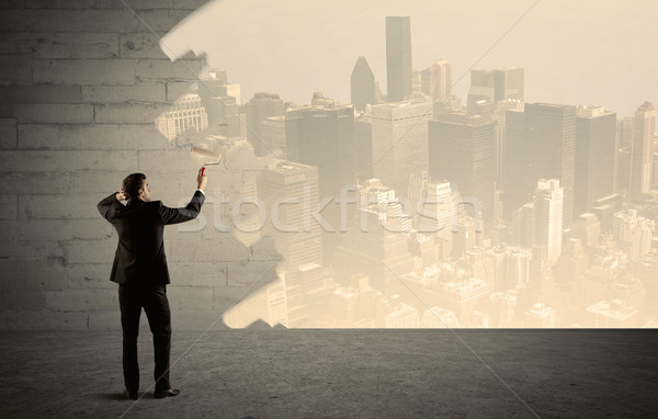 Salesman painting city scape on wall Stock photo © ra2studio