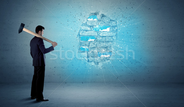 Business man hitting brick wall with huge hammer Stock photo © ra2studio