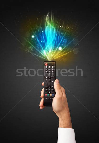 Hand with remote control and explosive signal Stock photo © ra2studio