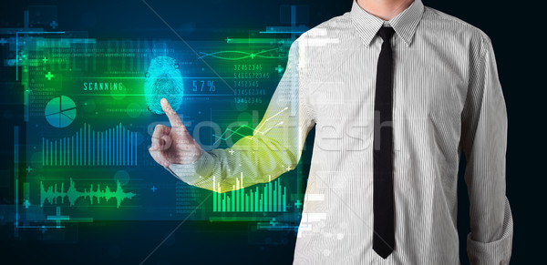 Young businessman pressing modern technology panel with finger p Stock photo © ra2studio