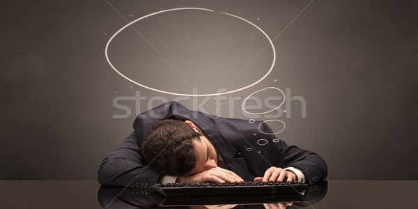 Businessman sleeping and dreaming at his workplace Stock photo © ra2studio