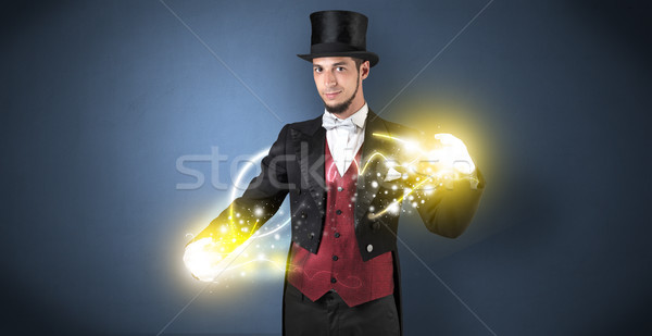 Magician holding his power on his hand Stock photo © ra2studio