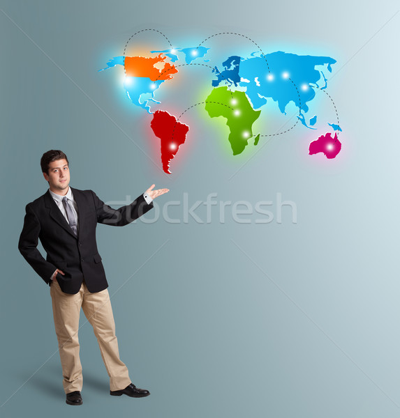  young man presenting colorful world map Stock photo © ra2studio