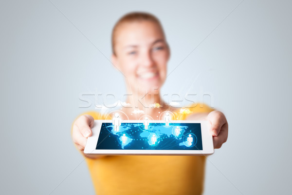 Beautiful woman holding modern tablet with social icons Stock photo © ra2studio