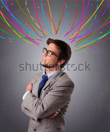 Young man thinking wiht colorful abstract lines overhead Stock photo © ra2studio