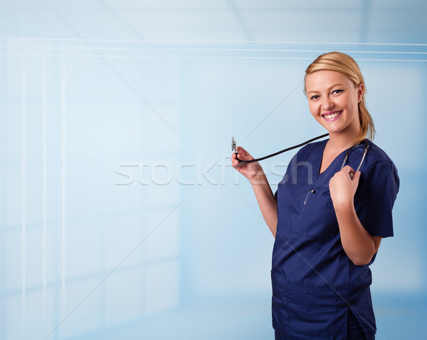 Pretty young nurse in hospital listening to empty copy space with sthetoscope Stock photo © ra2studio