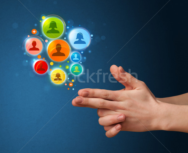 Social media icons coming out of gun shaped hand Stock photo © ra2studio