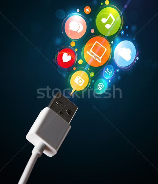 Social media icons coming out of electric cable Stock photo © ra2studio