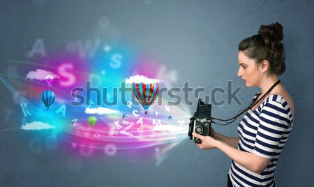 Worker with airbrush and colorful abstract clouds and balloons Stock photo © ra2studio