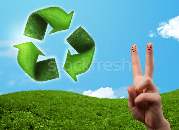 Happy smiley fingers looking at green leaf recycle sign Stock photo © ra2studio