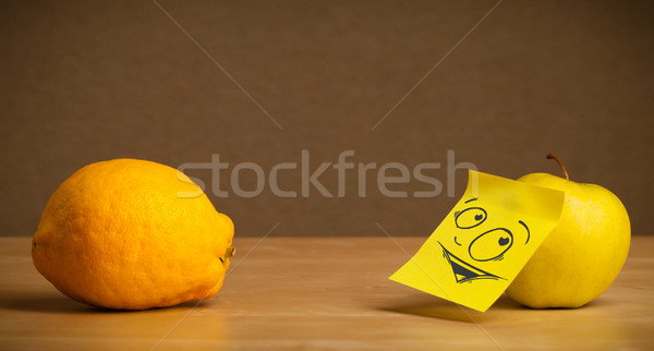 Apple with post-it note looking curiously at lemon Stock photo © ra2studio