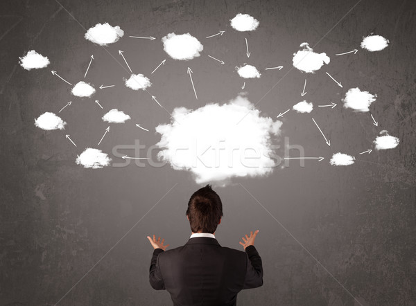 Businessman sitting with cloud technology above his head Stock photo © ra2studio