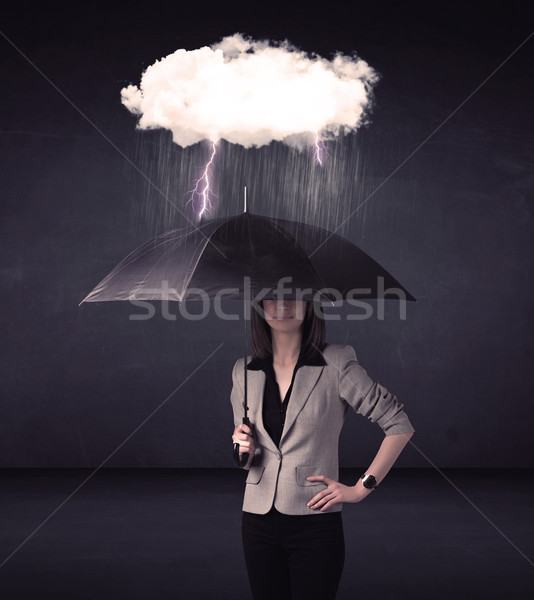 Businesswoman standing with umbrella and little storm cloud Stock photo © ra2studio