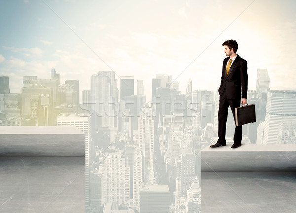 Businessman standing on the edge of rooftop Stock photo © ra2studio