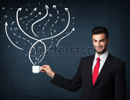 Stock photo: Businessman holding a white cup with lines and arrows