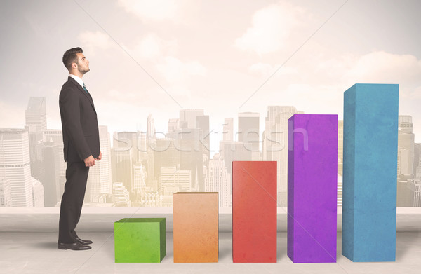 Business person climbing up on colourful chart pillars concept Stock photo © ra2studio