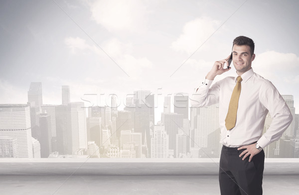 Sales person talking in front of city scape Stock photo © ra2studio