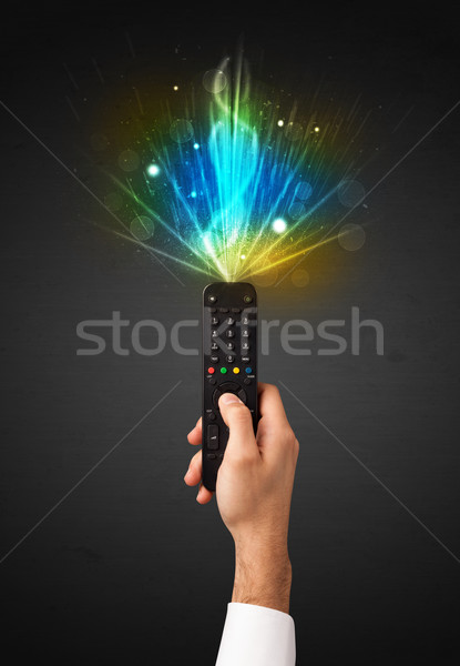 Hand with remote control and explosive signal Stock photo © ra2studio