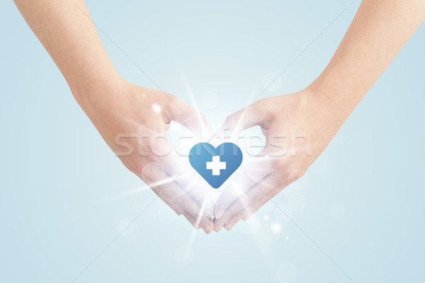 Mani forma cuore blu cross splendente Foto d'archivio © ra2studio
