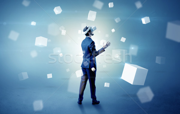 Businessman with vr goggle and falling cubes Stock photo © ra2studio
