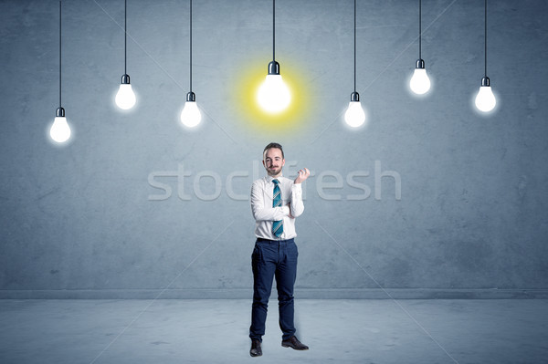 Stock photo: Businessman standing uninspired with bulbs above