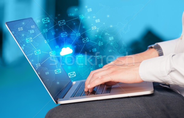 Hand using laptop with centralized cloud computing system concep Stock photo © ra2studio