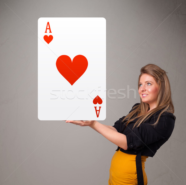 Beautifu woman holding a red heart ace Stock photo © ra2studio