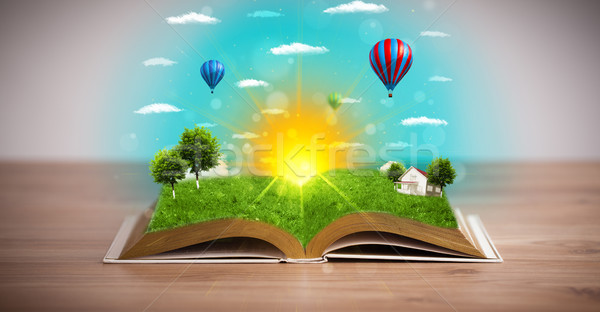 Open book with green nature world coming out of its pages Stock photo © ra2studio