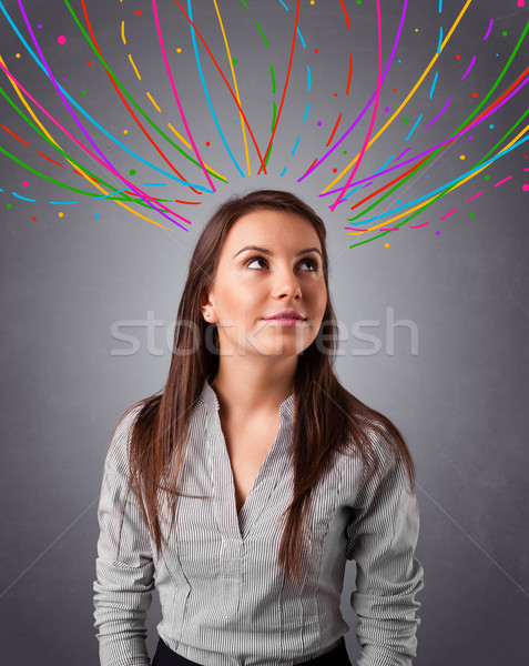 Young girl thinking with colorful abstract lines overhead Stock photo © ra2studio