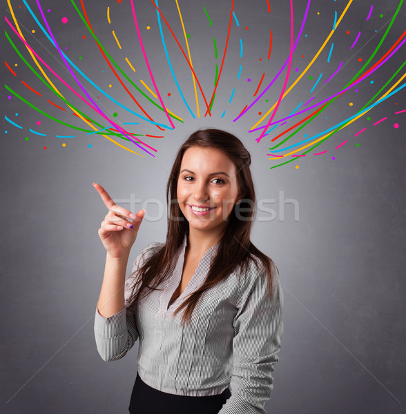 Young girl thinking with colorful abstract lines overhead Stock photo © ra2studio