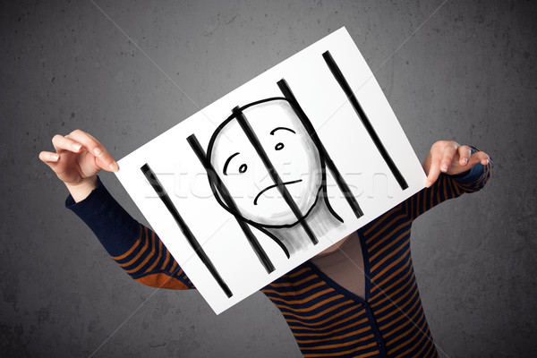 Woman holding a paper with a prisoner behind the bars on it in f Stock photo © ra2studio