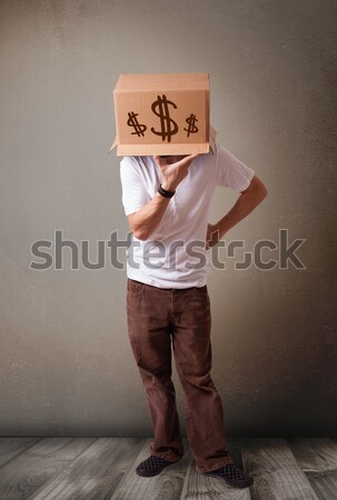 Young man gesturing with a cardboard box on his head with dollar Stock photo © ra2studio