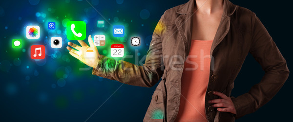 Young businesswoman pressing colorful mobile app icons with boke Stock photo © ra2studio