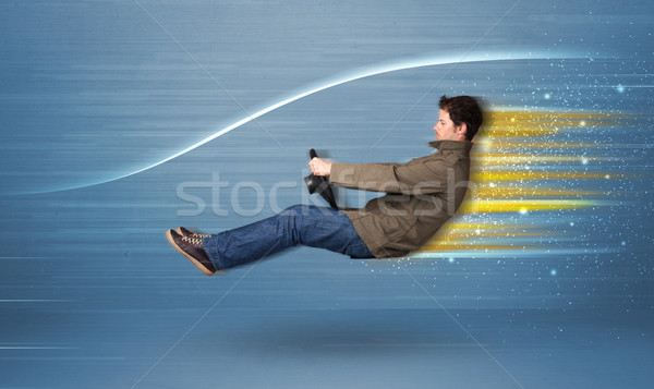 Young man driving in imaginary fast car with blurred lines  Stock photo © ra2studio