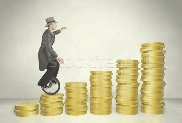 Business man riding monocycle up on coin graph Stock photo © ra2studio