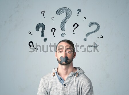 Young man with glued mouth and question mark symbols Stock photo © ra2studio